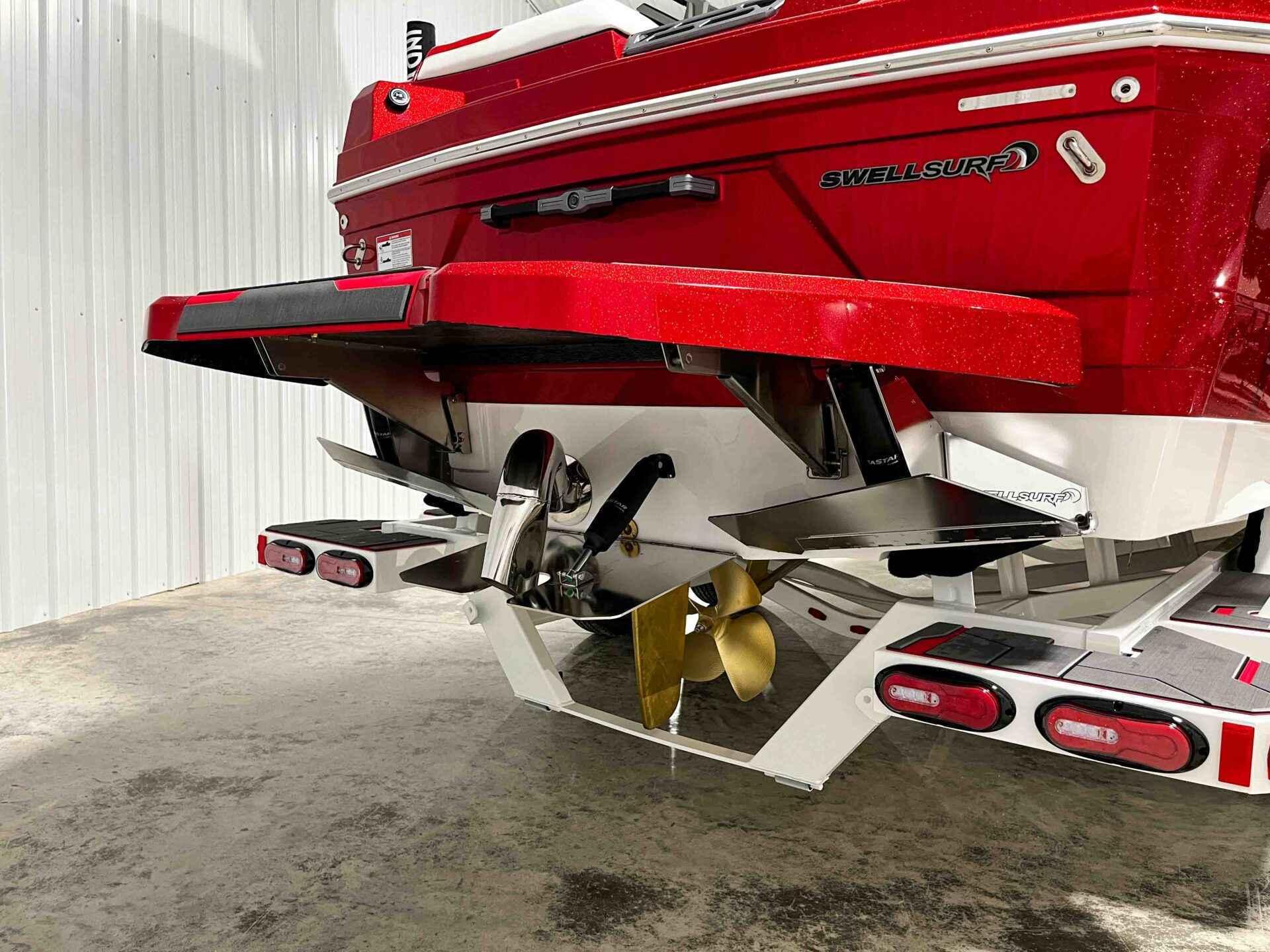 Slide: The Image of 2024 Supra SA400 boat rear view with SwellSurf system and propeller. - 8