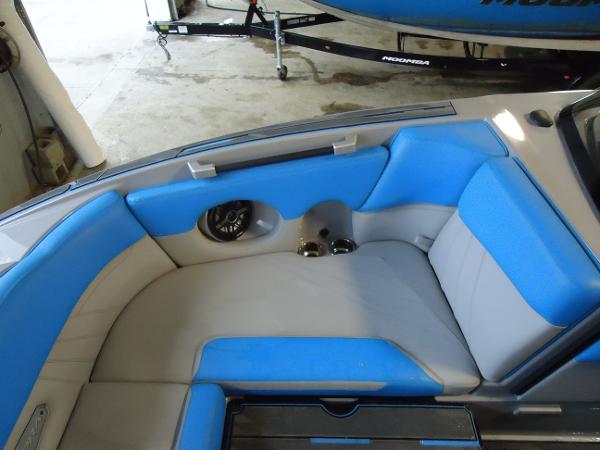 Slide: The Image of 2022 Supra SA 450 boat interior with blue and gray seating. - 11