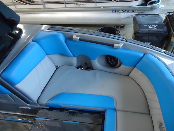 Slide: The Image of 2022 Supra SA 450 boat interior with blue and gray seating. - 12