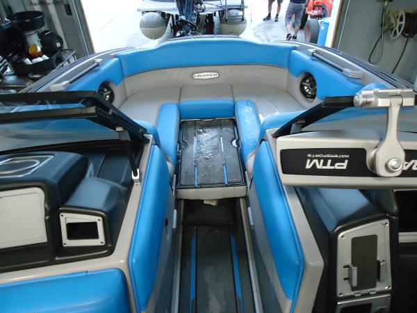 Slide: The Image of 2022 Supra SA 450 boat interior with blue and gray seating. - 13