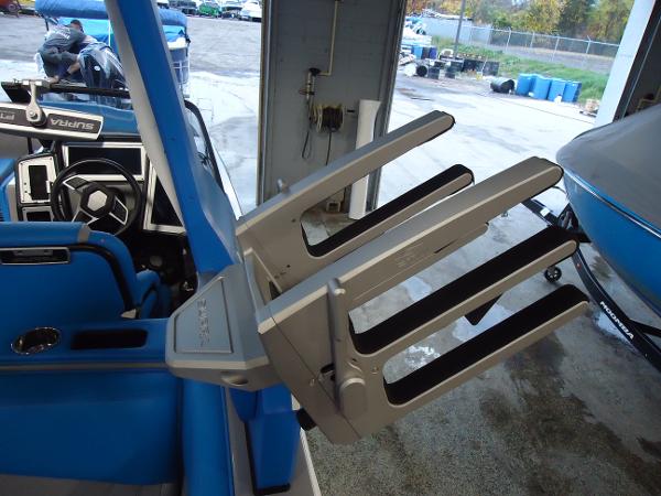 Slide: The Image of 2022 Supra SA 450 boat interior with wakeboard rack and blue seating. - 14