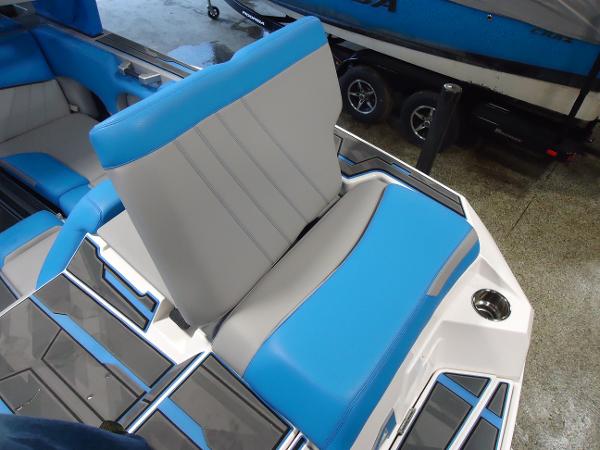 Slide: The Image of 2022 Supra SA 450 boat interior with blue and gray seating. - 17