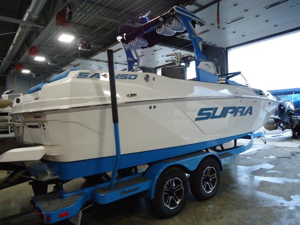 Slide: The Image of 2022 Supra SA 450 boat on a trailer in a garage. - 19
