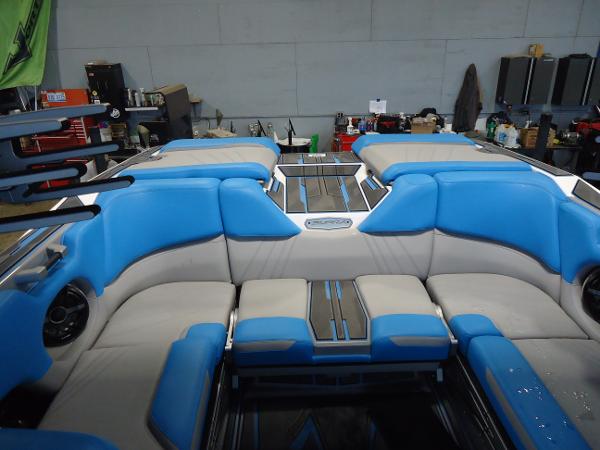 Slide: The Image of 2022 Supra SA 450 boat interior with blue and gray seating. - 2