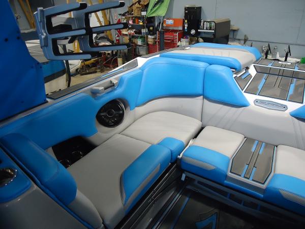 Slide: The Image of Interior of a 2022 Supra SA 450 boat with blue and white seating. - 7