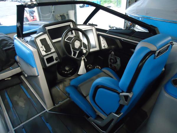 Slide: The Image of 2022 Supra SA 450 boat interior with blue and gray captain's seat and modern dashboard. - 8