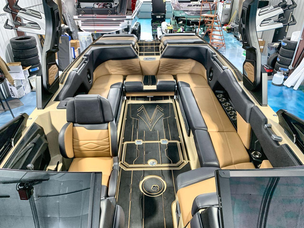 Slide: The Image of Luxurious interior of a 2025 Supra SE boat with tan and black seating. - 11