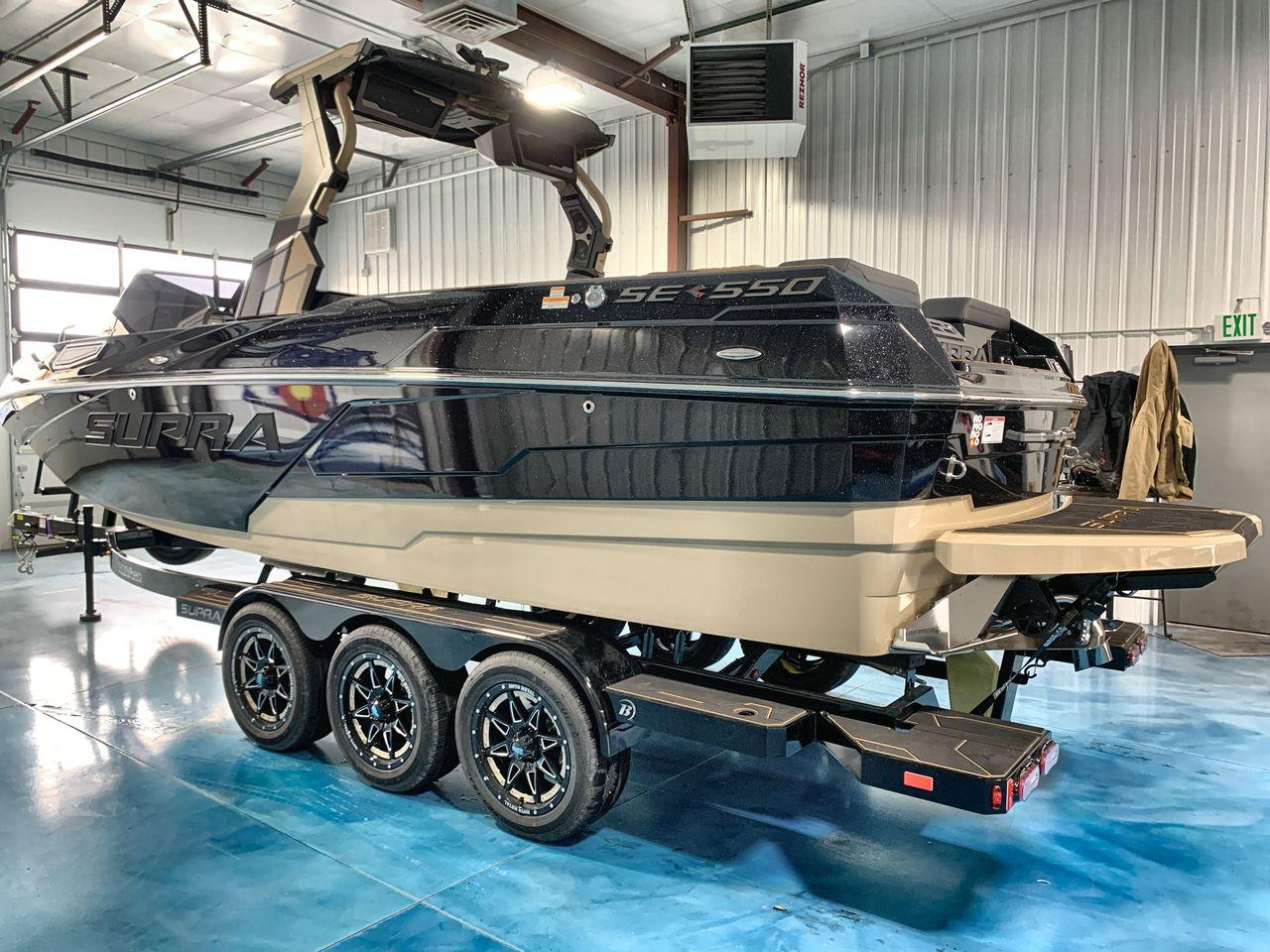 Slide: The Image of 2025 Supra SE boat on trailer in indoor storage facility. - 2