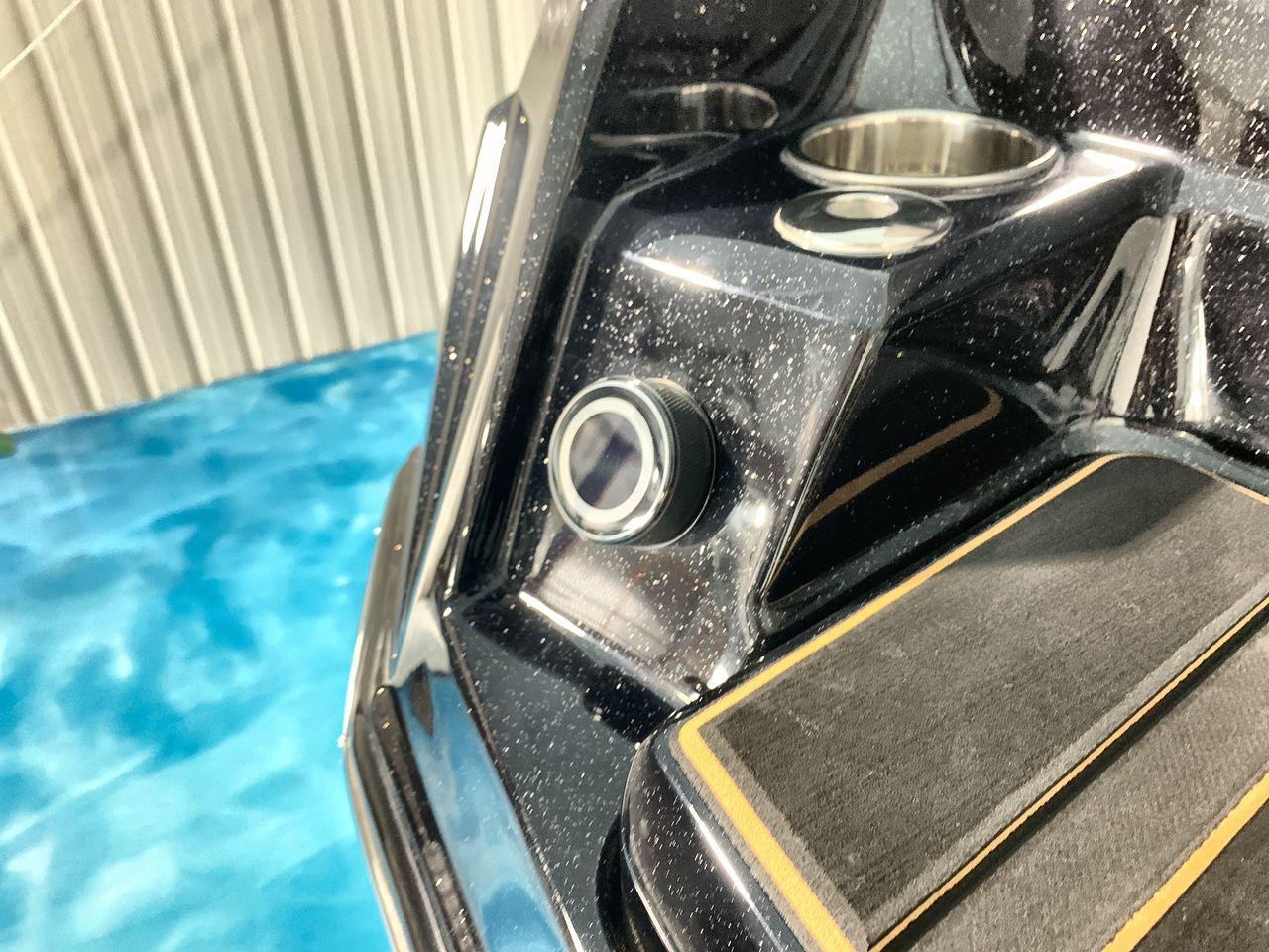Slide: The Image of 2025 Supra SE boat interior detail with cup holders and sleek design. - 26