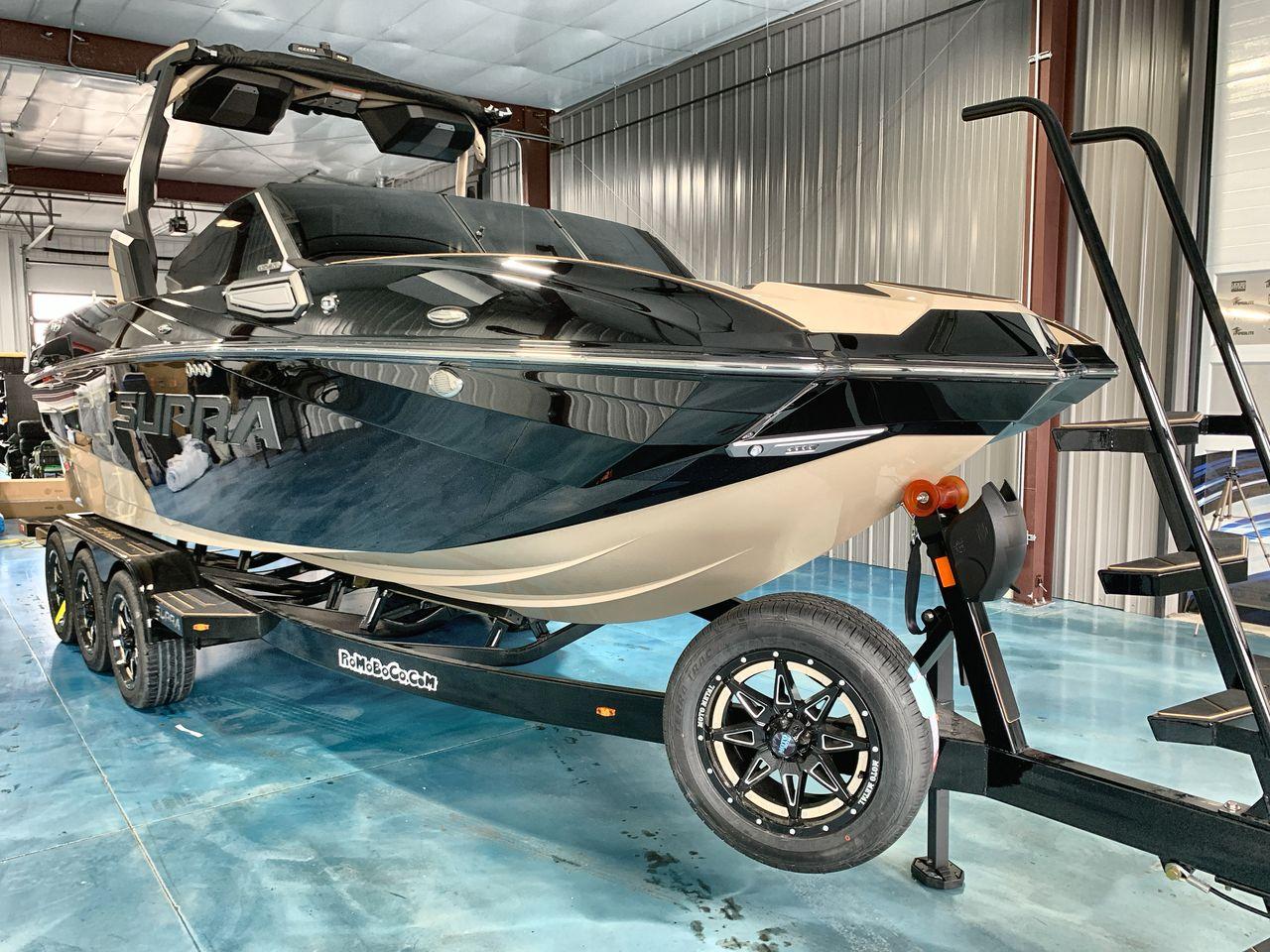 Slide: The Image of 2025 Supra SE boat on trailer in indoor showroom setting. - 6