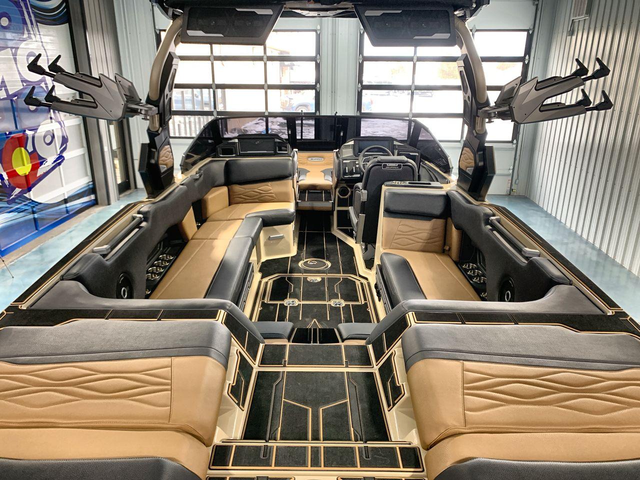 Slide: The Image of Luxurious interior of a 2025 Supra SE boat with tan and black seating. - 8