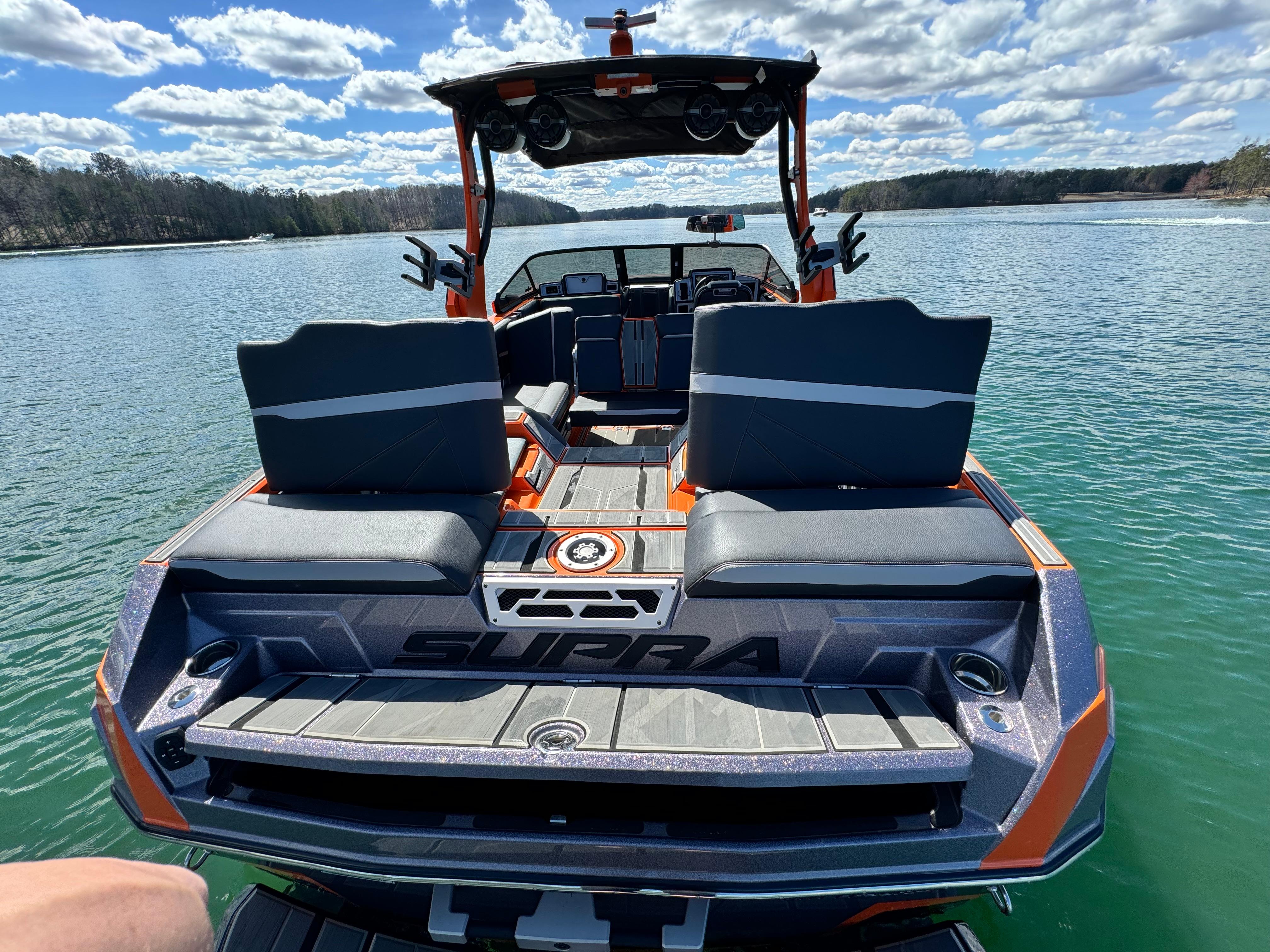 Slide: The Image of 2022 Supra SL 550 boat on a lake, featuring sleek seating and modern design. - 10