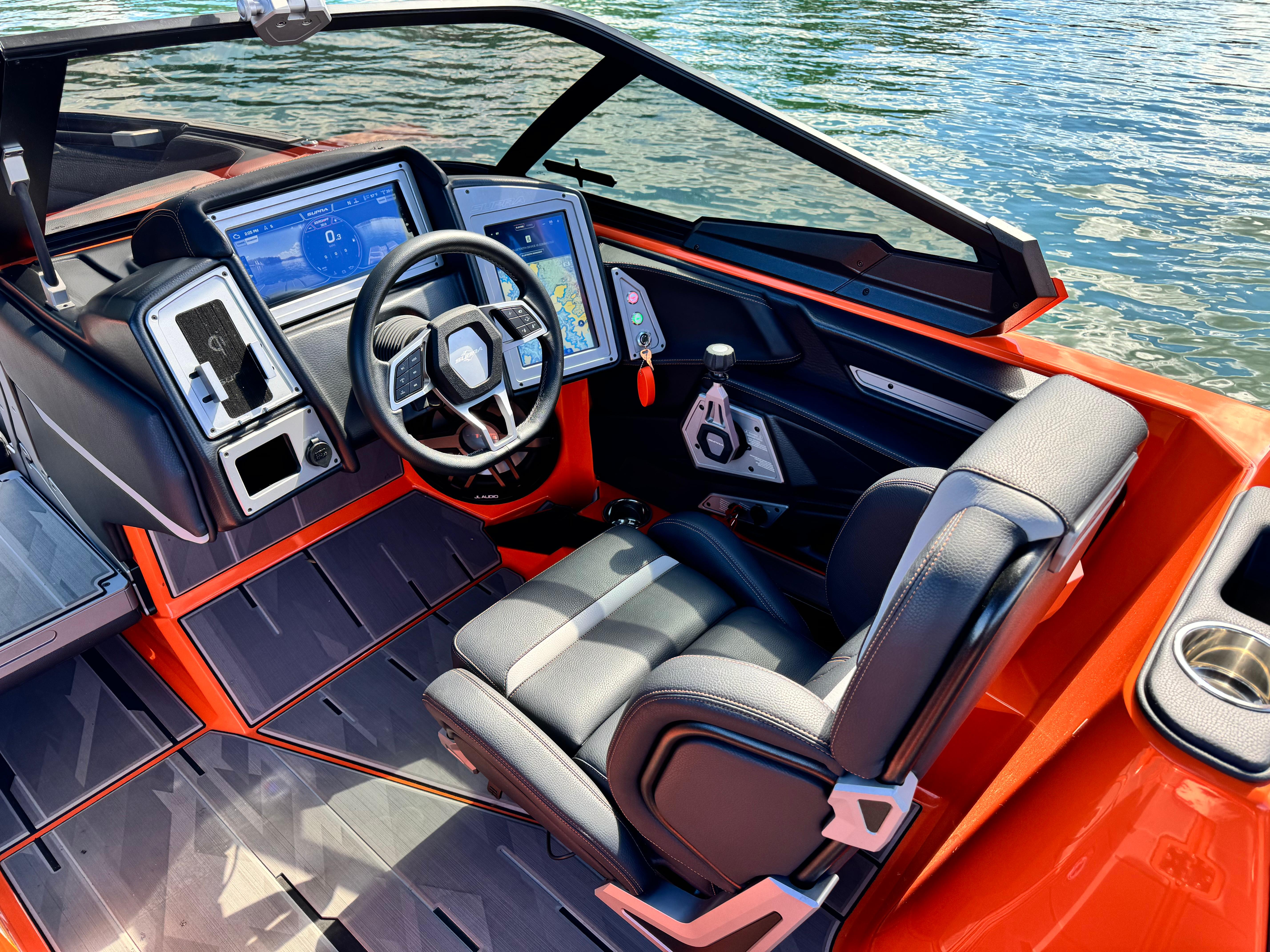 Slide: The Image of 2022 Supra SL 550 boat interior with modern dashboard and steering wheel on water. - 3