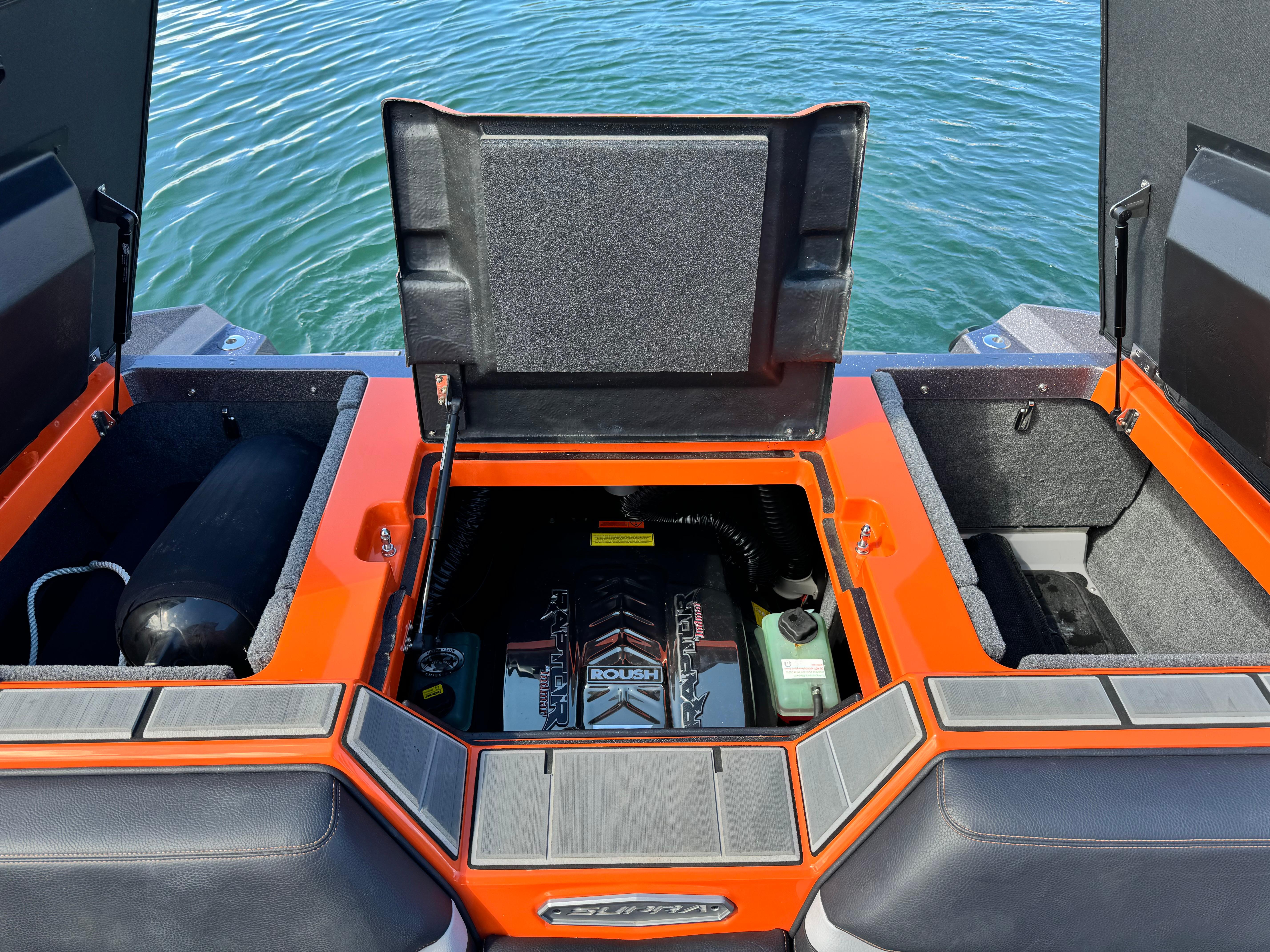 Slide: The Image of 2022 Supra SL 550 boat engine compartment with open hatches, revealing Roush engine. - 9