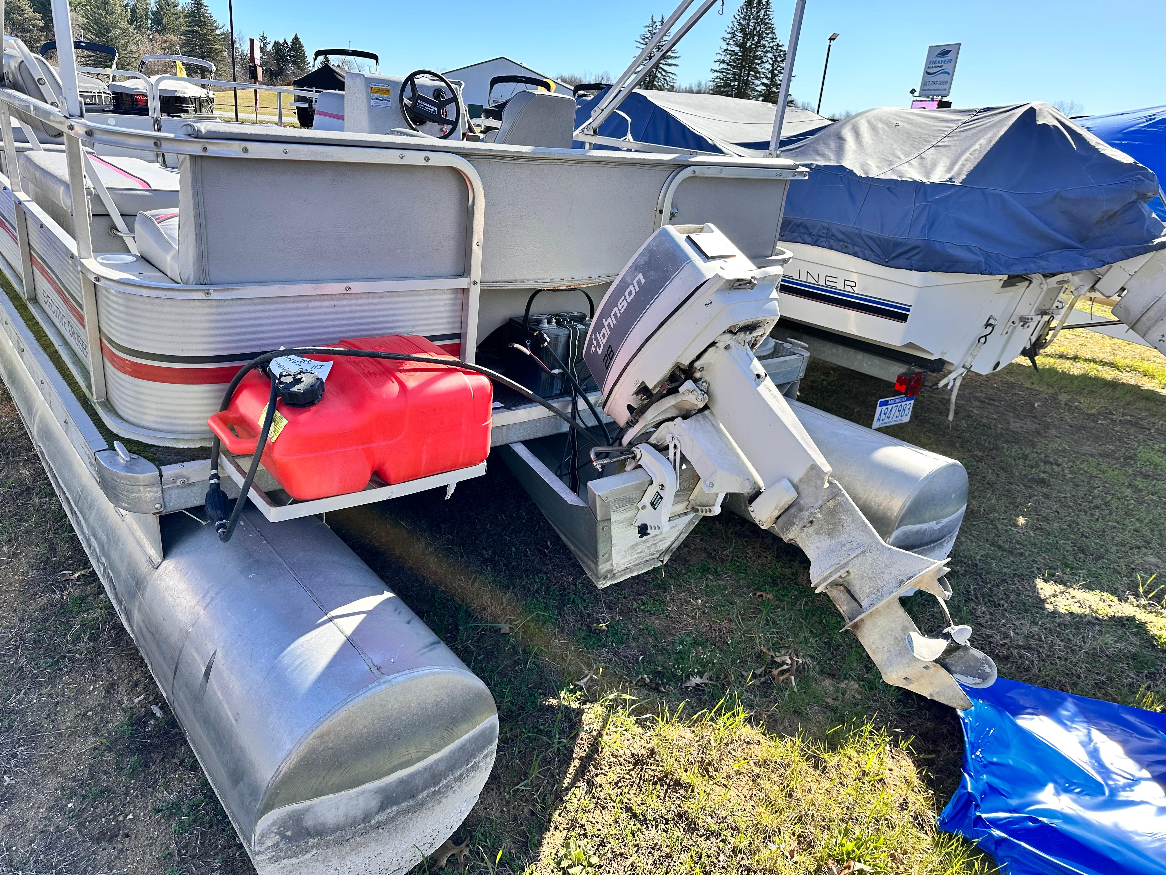 Slide: The Image of 1987 Sweetwater Pontoon boat with Johnson outboard motor and red fuel tank. - 3