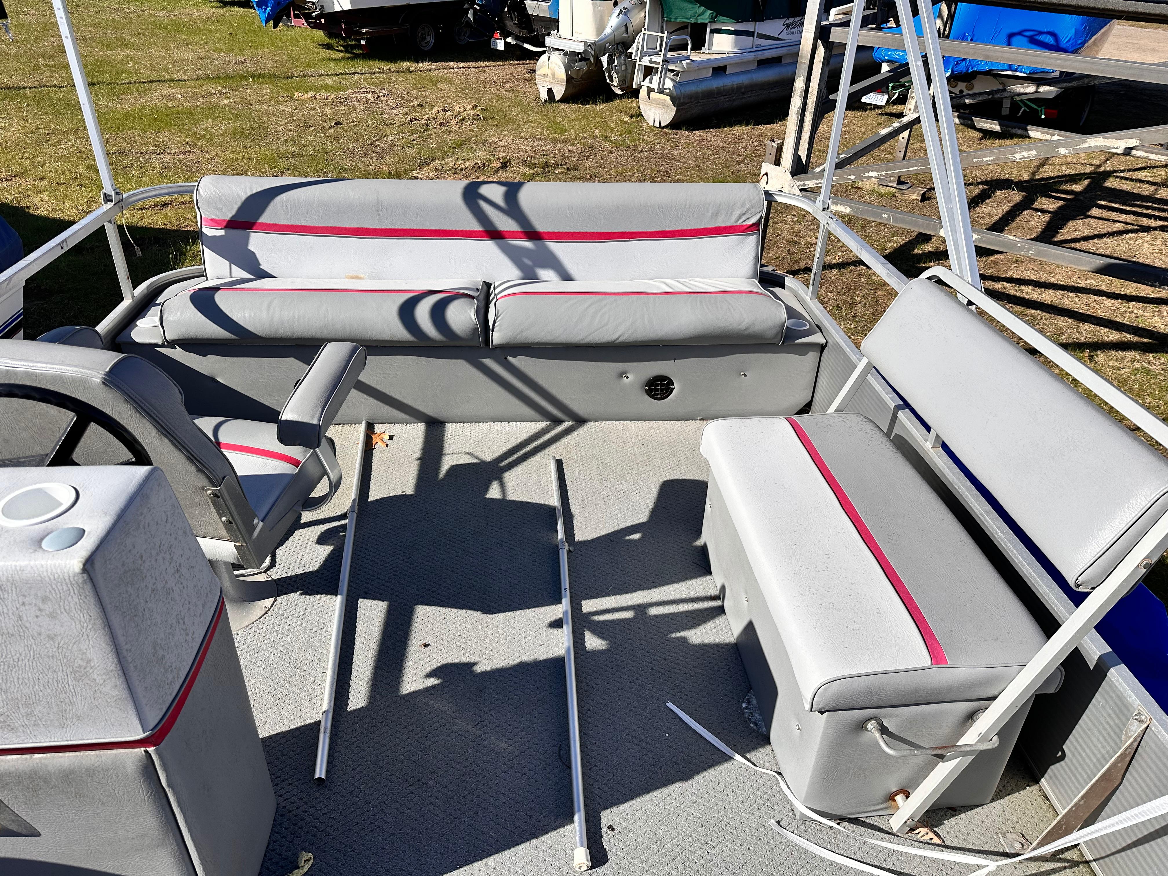 Slide: The Image of 1987 Sweetwater Pontoon boat interior with gray and red seating. - 5