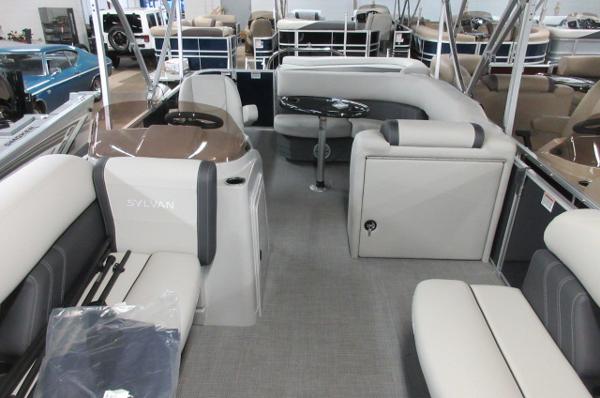 Slide: The Image of 2023 Sylvan 820 Mirage Cruise RE interior with plush seating and modern design. - 2
