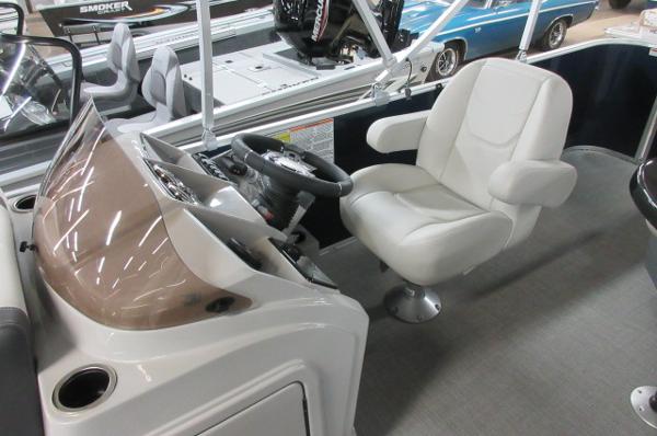 Slide: The Image of 2023 Sylvan 820 Mirage Cruise RE boat interior with captain's chair and control panel. - 5
