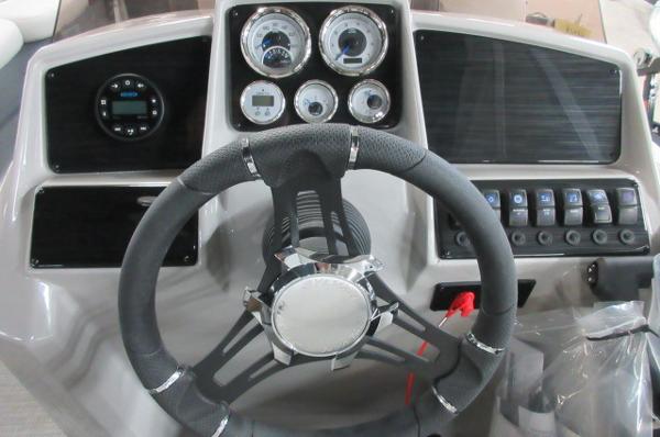 Slide: The Image of 2023 Sylvan 820 Mirage Cruise RE dashboard with steering wheel and control gauges. - 6