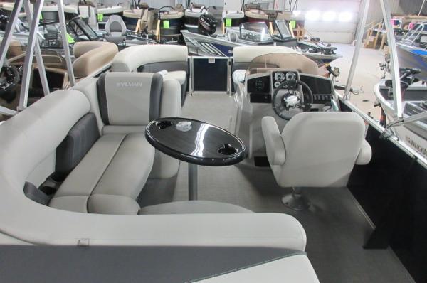 Slide: The Image of 2023 Sylvan 820 Mirage Cruise RE interior with plush seating and modern helm. - 9