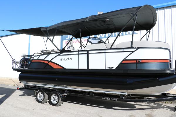 Slide: The Image of 2025 Sylvan L3 DLZ Bar Tri-Toon boat on trailer, featuring sleek design and canopy. - 0