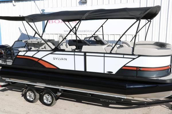 Slide: The Image of 2025 Sylvan L3 DLZ Bar Tri-Toon pontoon boat with black canopy and sleek design. - 13