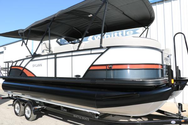 Slide: The Image of 2025 Sylvan L3 DLZ Bar Tri-Toon pontoon boat with black canopy on trailer. - 15