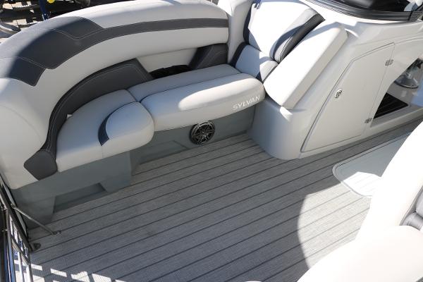 Slide: The Image of 2025 Sylvan L3 DLZ Bar Tri-Toon boat interior with gray seating and flooring. - 21