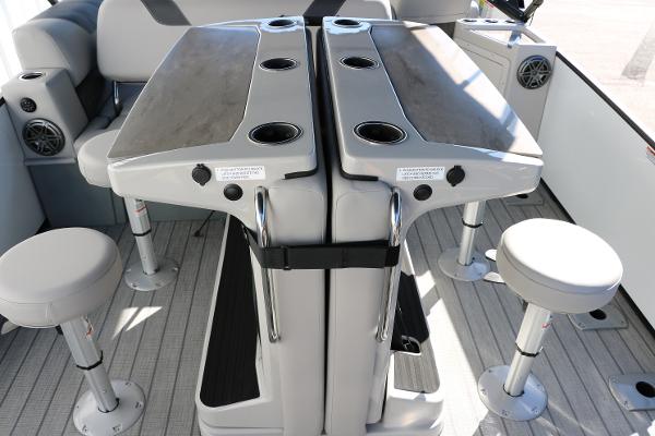 Slide: The Image of 2025 Sylvan L3 DLZ Bar Tri-Toon interior with bar seating and cup holders. - 28