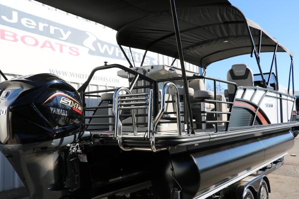 Slide: The Image of 2025 Sylvan L3 DLZ Bar Tri-Toon boat with Yamaha engine, showcased at a dealership. - 3