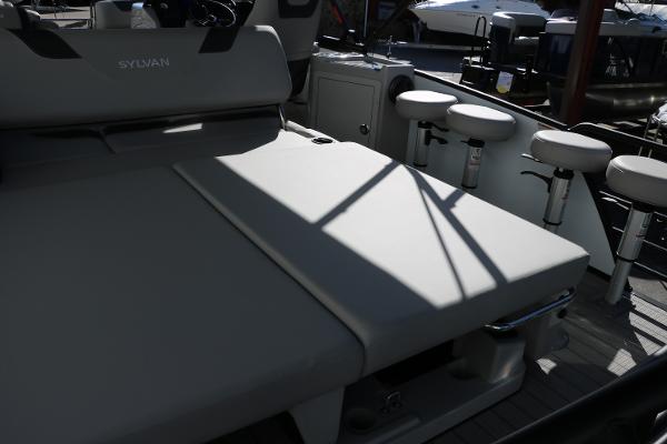 Slide: The Image of 2025 Sylvan L3 DLZ Bar Tri-Toon boat interior with seating and bar stools. - 34
