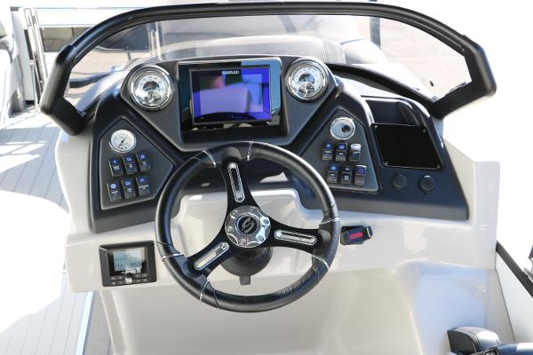 Slide: The Image of 2025 Sylvan L3 DLZ Bar Tri-Toon dashboard with steering wheel and control panel. - 37