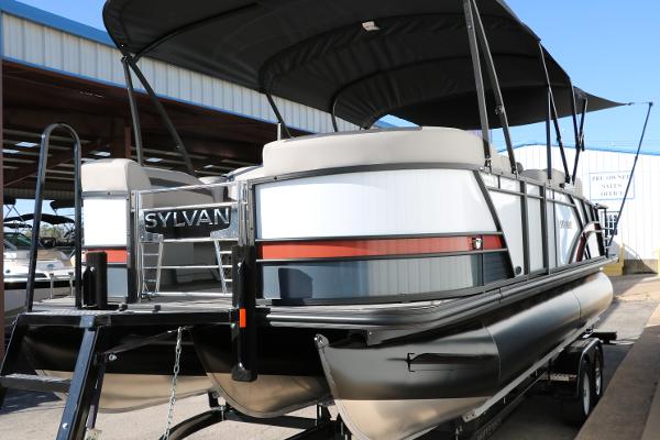 Slide: The Image of 2025 Sylvan L3 DLZ Bar Tri-Toon pontoon boat on trailer, featuring sleek design and canopy. - 9