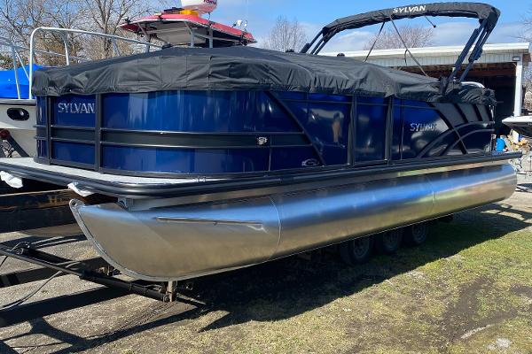 Slide: The Image of 2024 Sylvan Mirage 8522 LZ pontoon boat with blue exterior and black cover. - 0