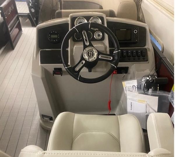 Slide: The Image of 2024 Sylvan Mirage 8522 LZ boat dashboard with steering wheel and control panel. - 3