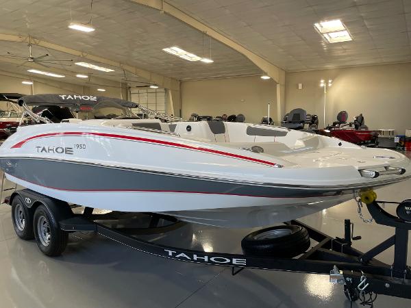 Slide: The Image of 2023 Tahoe 1950 boat on trailer in showroom. - 1