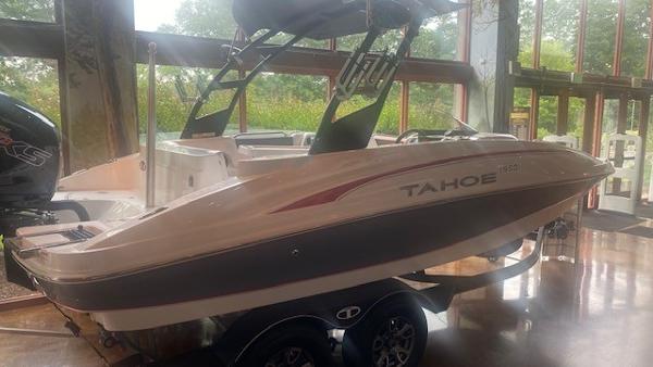Slide: The Image of 2023 Tahoe 1950 boat on display indoors. - 1