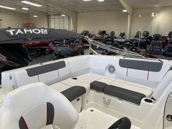 Slide: The Image of 2023 Tahoe 1950 boat interior with white and gray seating in showroom. - 11