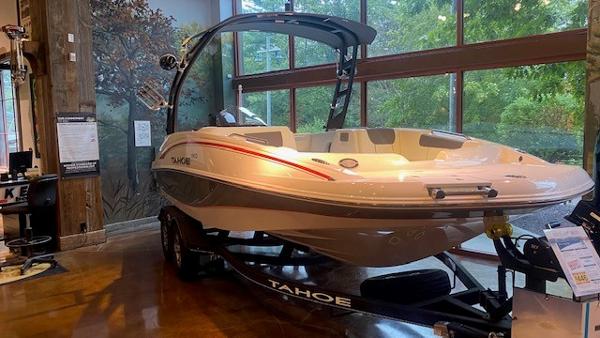 Slide: The Image of 2023 Tahoe 1950 boat on display indoors. - 2