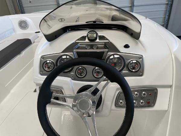 Slide: The Image of Tahoe 1950 boat dashboard, 2023 model, featuring steering wheel and control gauges. - 7