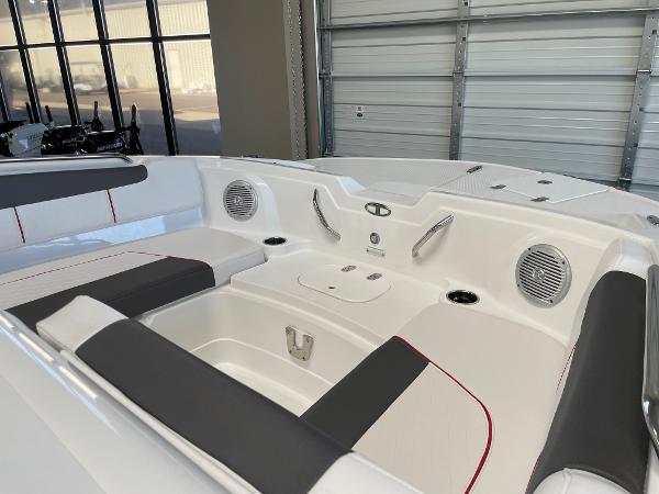 Slide: The Image of Interior of 2023 Tahoe 1950 boat with seating and speakers in a garage. - 8