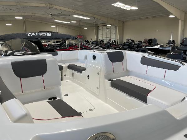 Slide: The Image of 2023 Tahoe 1950 boat interior with gray and white seating in showroom. - 9