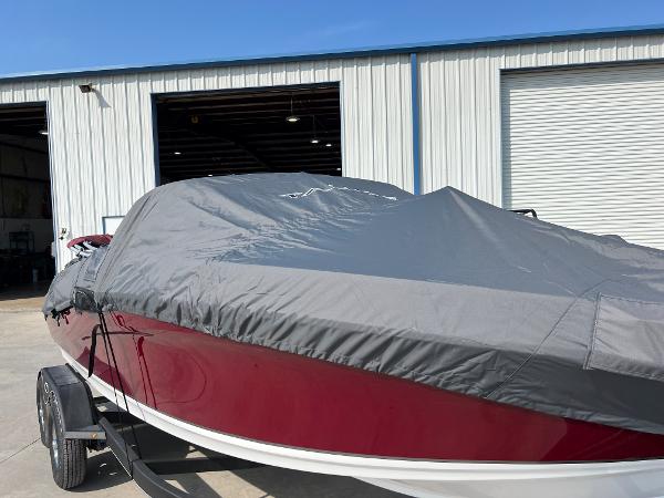 Slide: The Image of 2023 Tahoe 200 S boat with cover in front of a storage facility. - 10