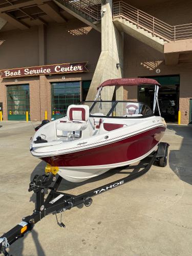 Slide: The Image of 2024 Tahoe 200 S boat in front of a boat service center. - 0