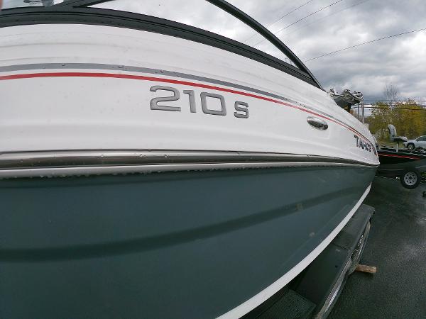 Slide: The Image of 2024 Tahoe 210 S boat side view with model name and logo. - 1
