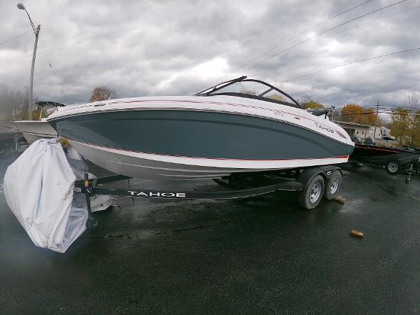 Slide: The Image of 2024 Tahoe 210 S boat on trailer under cloudy sky. - 2