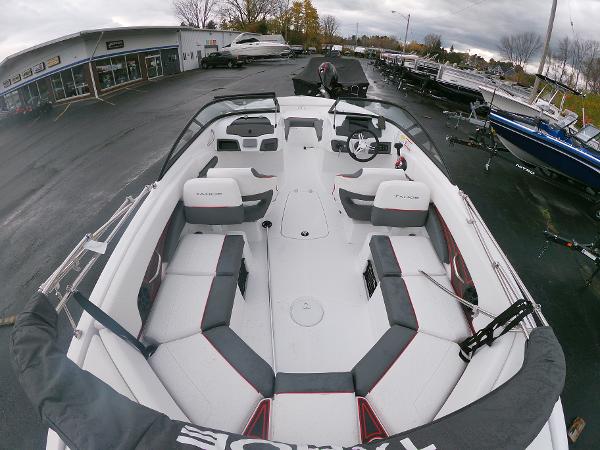 Slide: The Image of 2024 Tahoe 210 S boat with spacious seating, displayed at a dealership. - 3