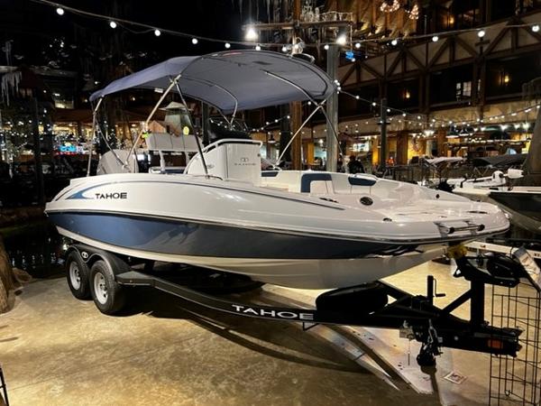 Slide: The Image of 2024 Tahoe 2150 CC boat on display with trailer in a showroom. - 0