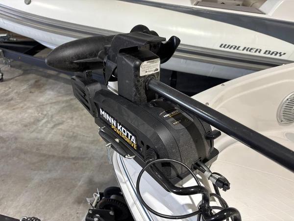 Slide: The Image of Minn Kota trolling motor on 2020 Tahoe 450 TF boat, in a garage setting. - 11