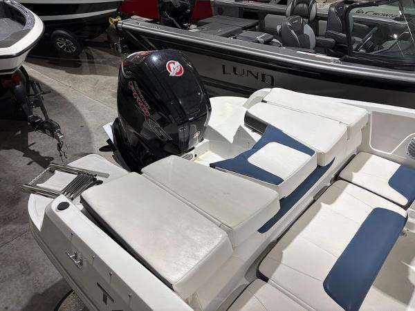 Slide: The Image of 2020 Tahoe 450 TF boat with Mercury outboard motor in showroom. - 6